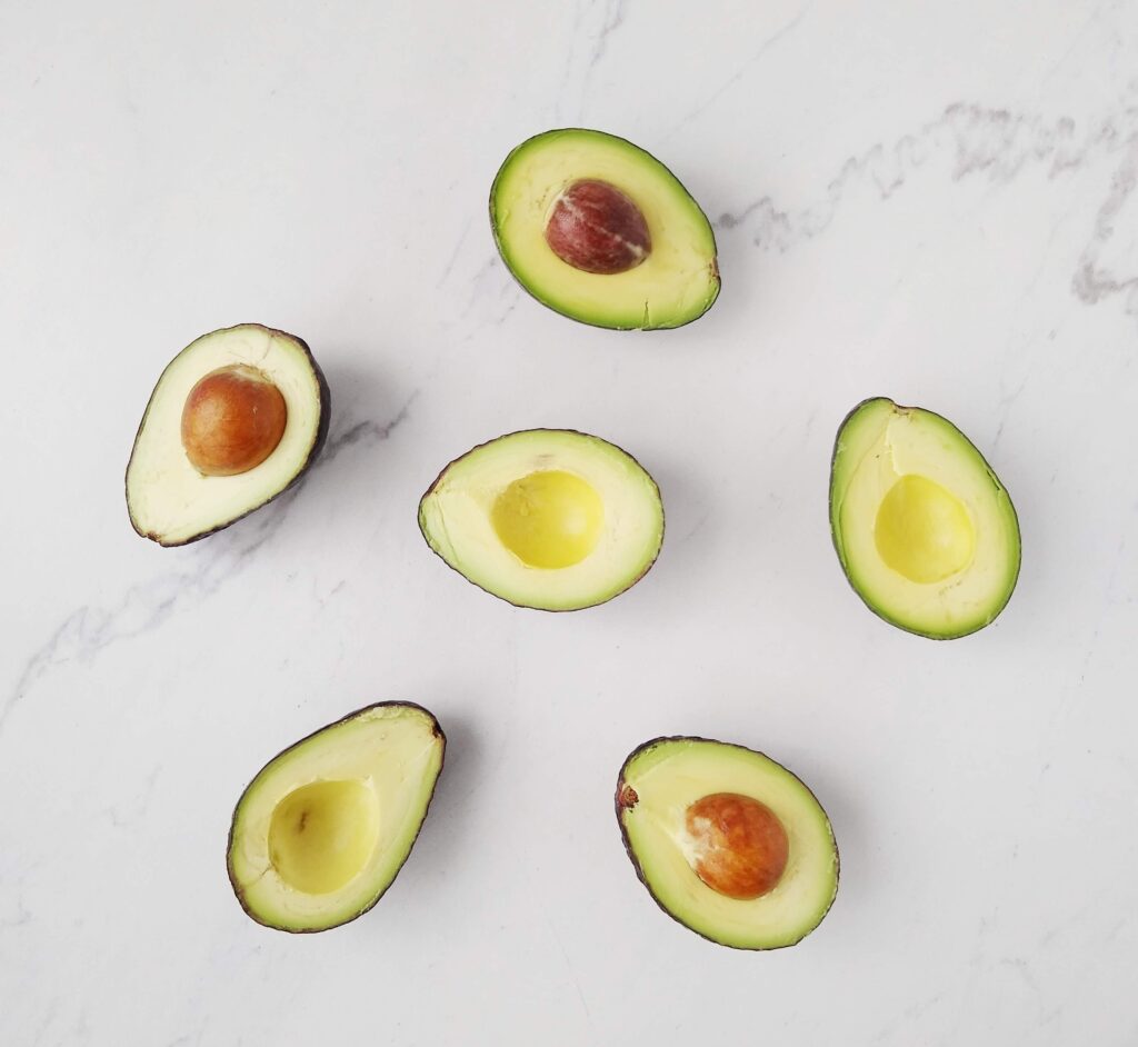 avocado halves, face up on a white background