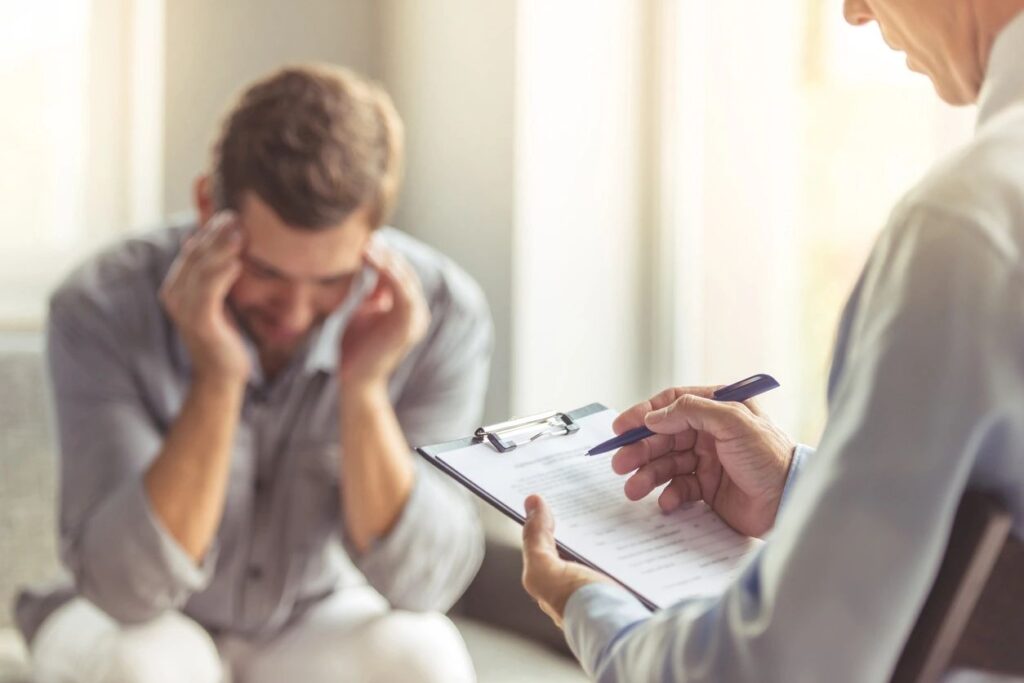 man feeling overwhelmed by his goals